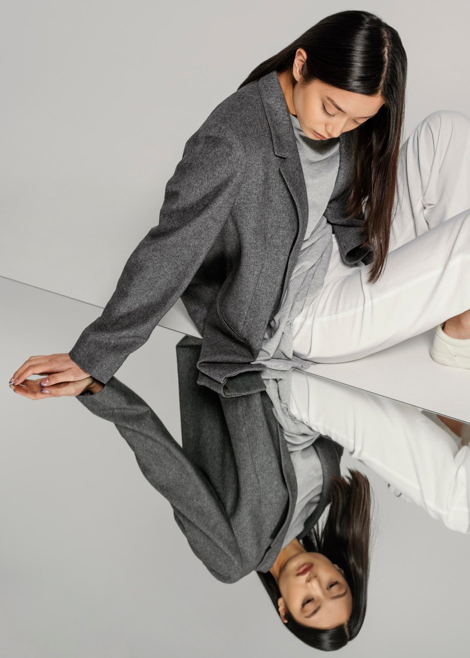 young japanese woman with jacket posing mirror