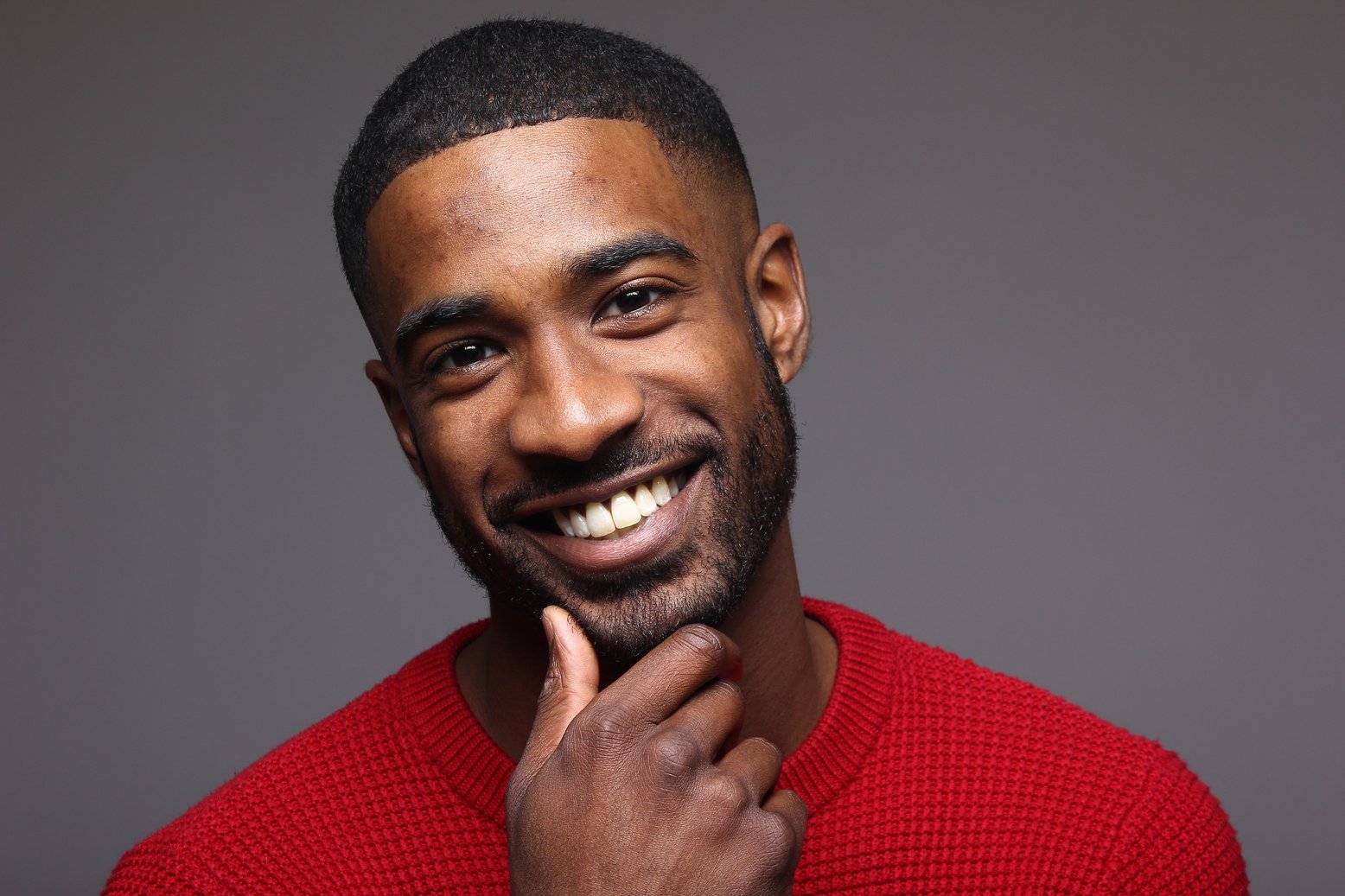 Portrait of a Smiling Man in Red Shirt